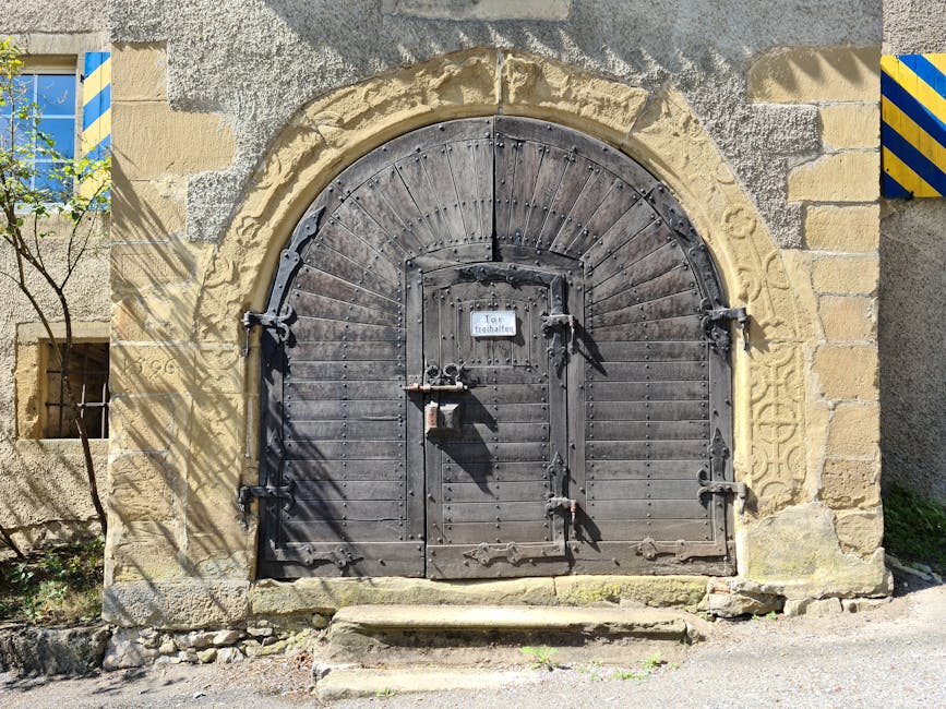 Ancient wooden door with arch in Neckarzimmern, Germany, showcasing rustic design.