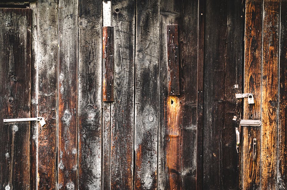 A close-up of an old, weathered wooden door showcasing rustic textures and natural wear.